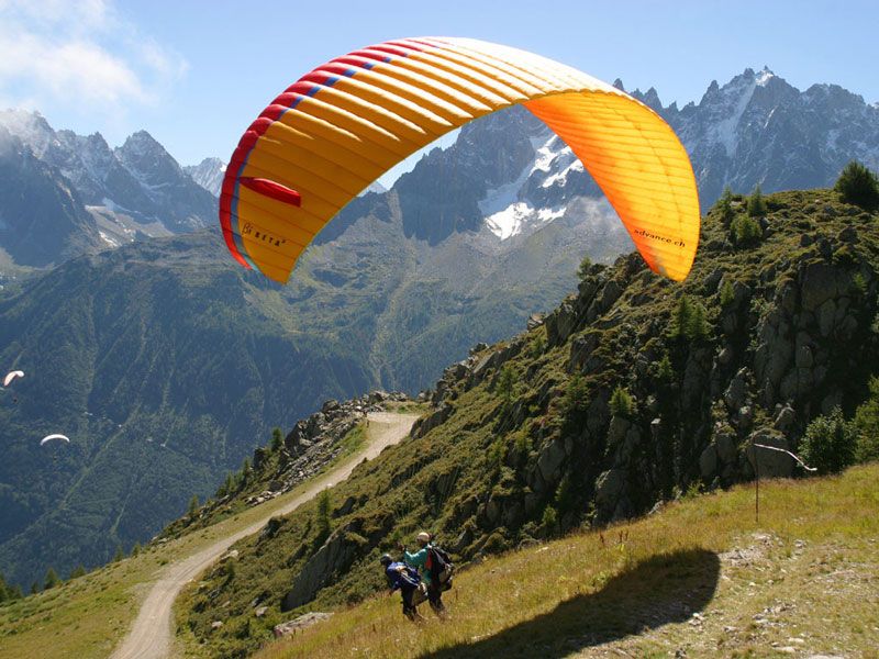 Alpine paragliding in Chamonix with views of the incredible valley on a summer's day. 