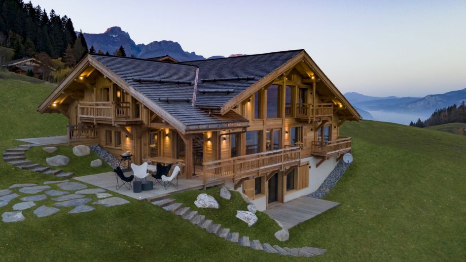 It's in the name at Chalet My View! This secluded mountain chalet features a charming alpine exterior, surrounded by greenery, and looking out to far-reaching mountain views in the background.