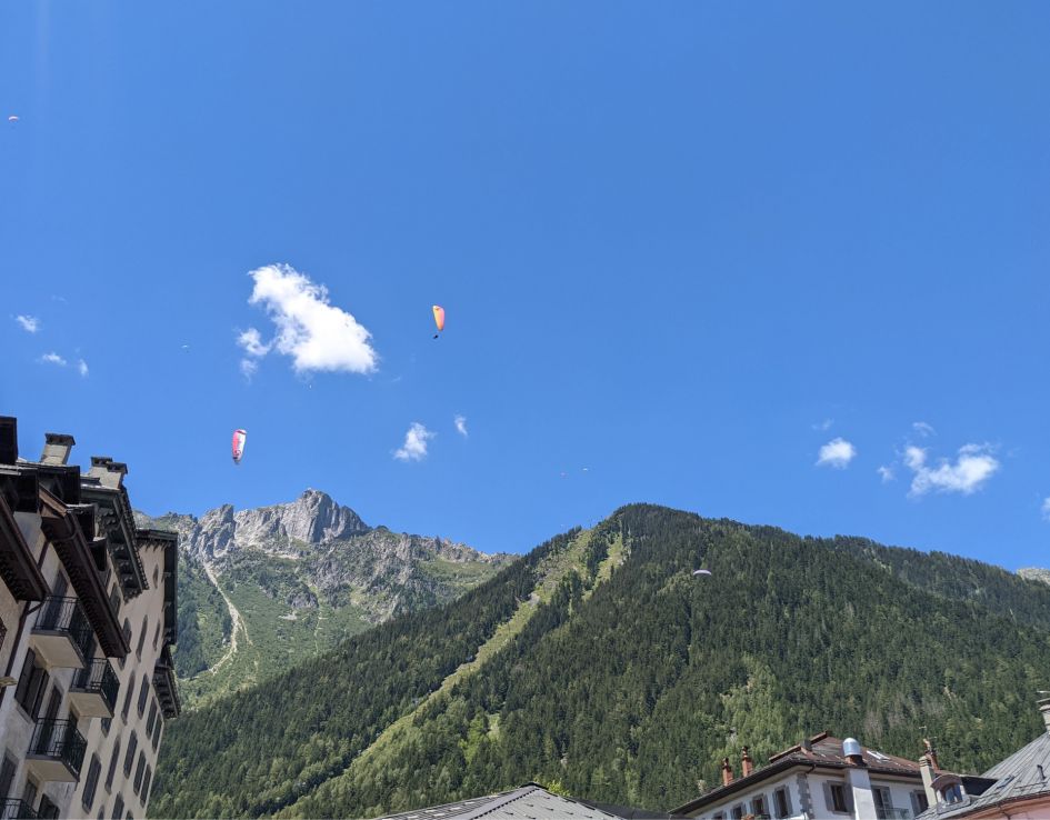 Mountains, Mountains, Mountains... When on a Chamonix summer holiday, the paragliders between the mountains on either side of the valley, including the Mont Blanc Massif, are clear to see in the sun!