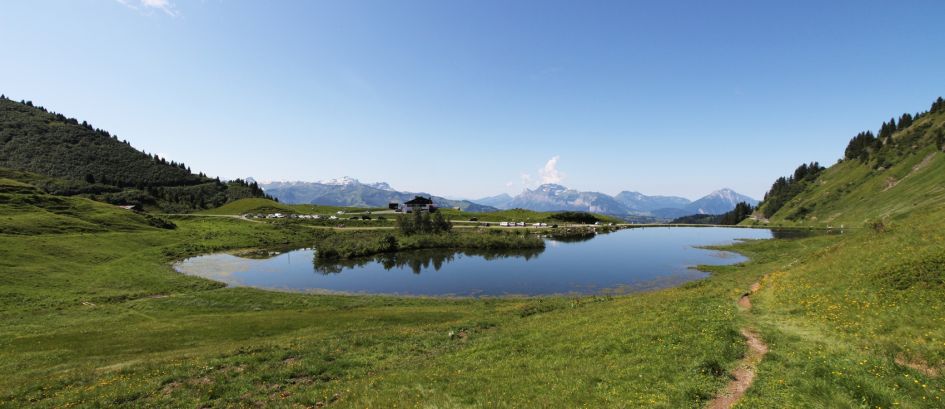 Morzine in the summer by a peaceful lake at the Geopark