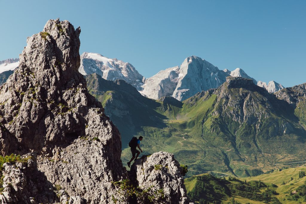 mountain skyline above Arabba with a trail runner reaching a peak