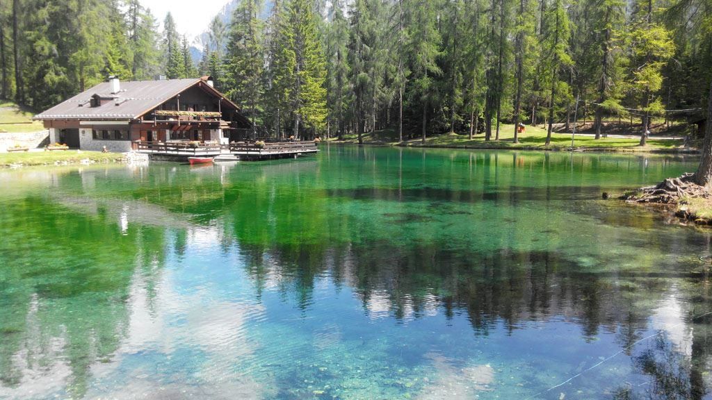 Image of water and cafe on Lake Ghedina - one of the lakes in the Dolomites.