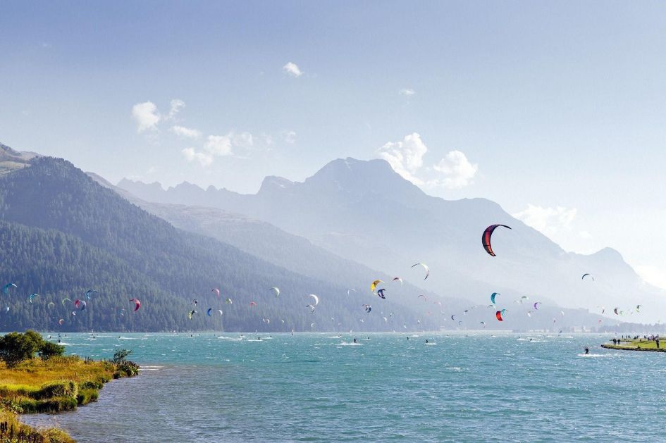 Lakes and mountain holidays offer both a chance to enjoy an activity-filled mountain getaway, such as all the paragliders circling above the water in this photo, or for a relaxing break.