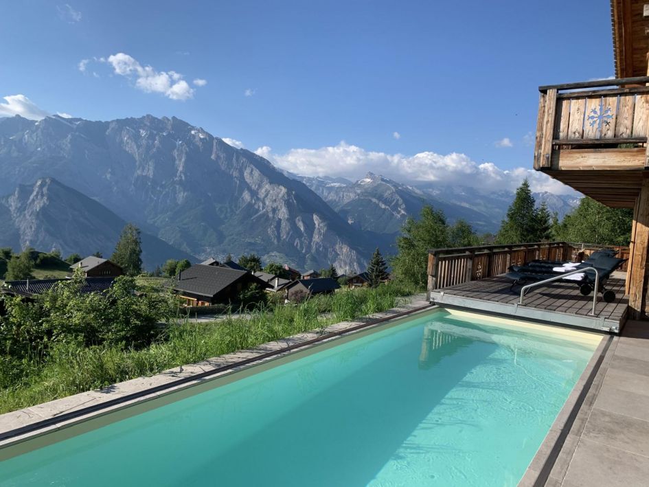 Chalet V's outdoor swimming pool and terrace look out to stunning panoramic mountain views - what more could you wish for on a luxury summer alpine retreat in Verbier?