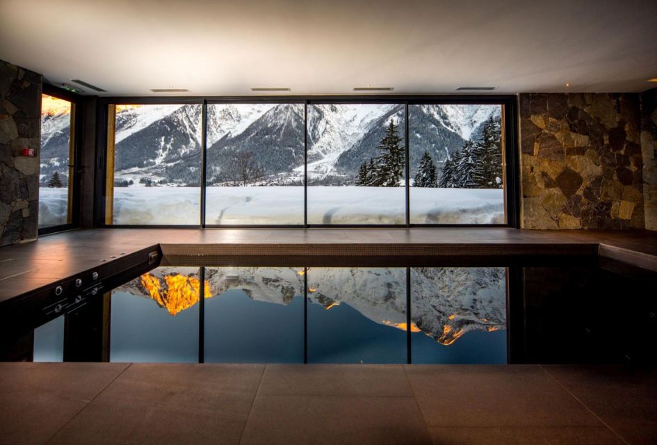 The view from the luxury swimming pool of Le Chalet Mont Blanc with the mountains reflecting off the water. A great view for a luxury summer chalet holiday with a view in Chamonix