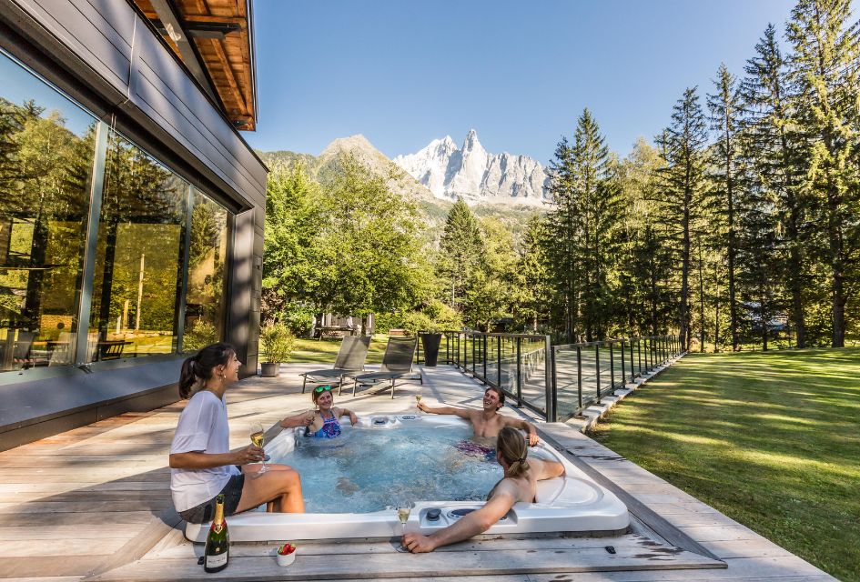 Chalet Dalmore, Chamonix Outdoor hot tub on the terrace that is elevated with stunning mountain views and peaceful forest surroundings.