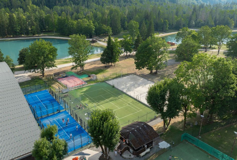Two padel courts situated next to a beautiful lake. From the courts, you can also gaze across at the amazing forest views ahead.
