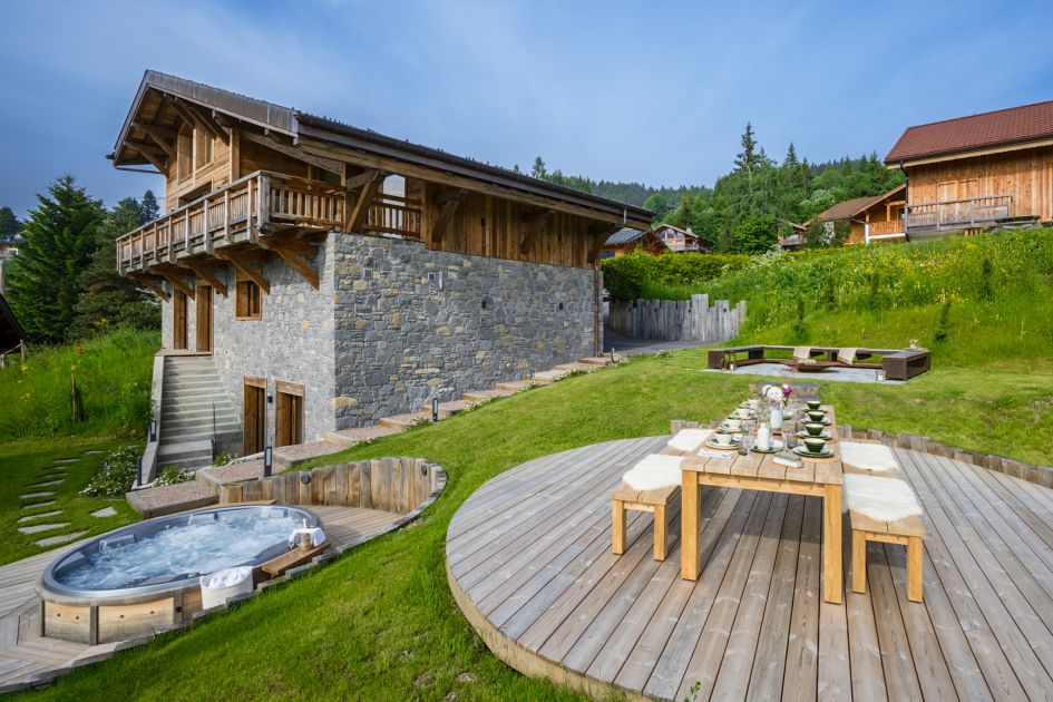 Chalet Tosca, Les Gets The spacious garden featuring an outdoor hot tub, a fire pit for casual conversation, plus a large table where the group can dine alfresco.