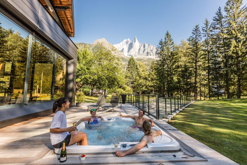 Chalet Dalmore, Chamonix Outdoor hot tub on the terrace that is elevated with stunning mountain views and peaceful forest surroundings.