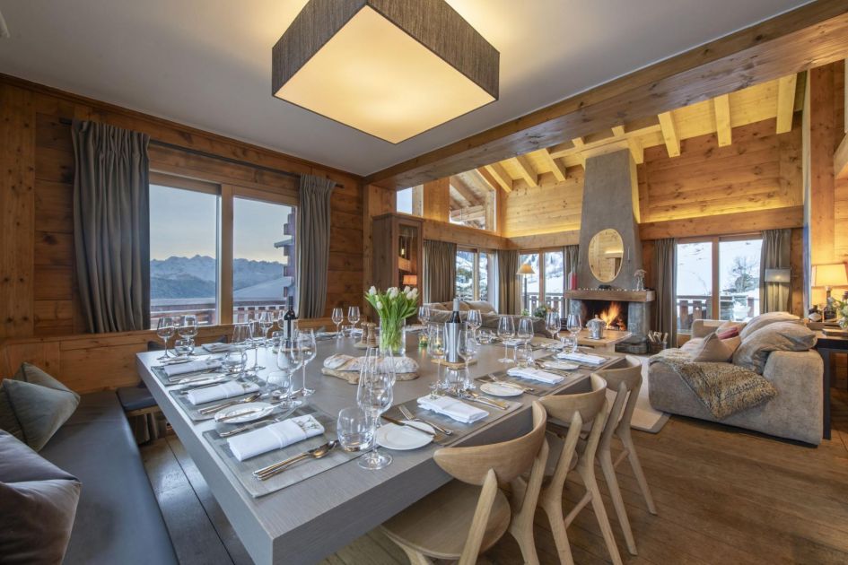 Traditional yet elegant alpine designs fill the interiors of Chalet Pierre Avoi. Sit together at the large dining table each evening.