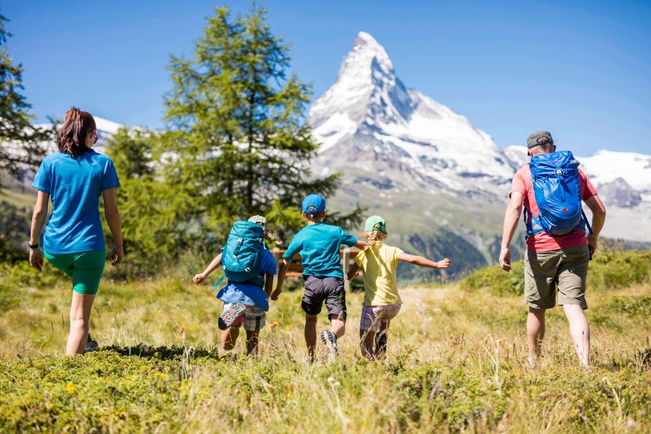 A family hiking through Zermatt with sensational views of the iconic Matterhorn ahead.
