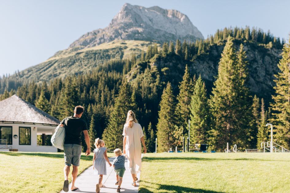 A family enjoying a day out together in Lech with forest mountain views.