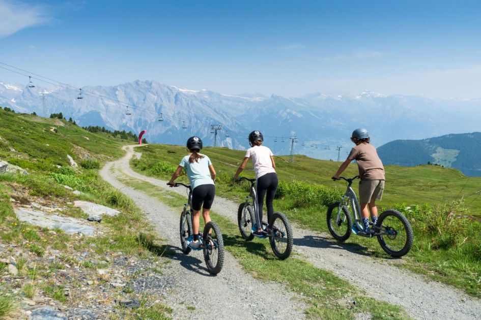 Credit: Verbier Tourism Three children out on mountain bikes exploring the scenic trails that Verbier offers.