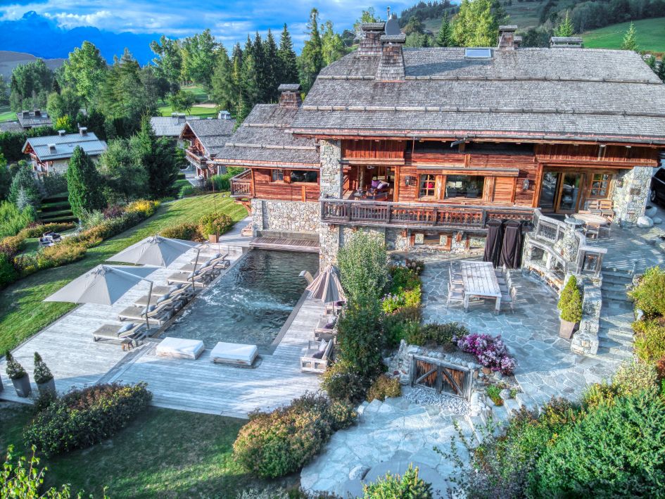sizeable summer chalet in Megève, alfresco dining and a swimming pool with poolside loungers