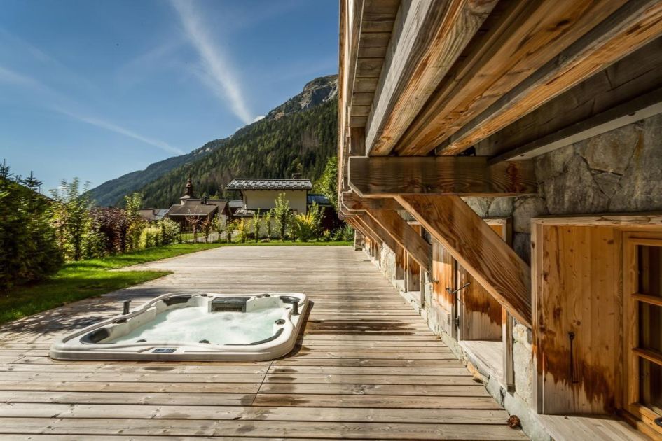 Expansive terrace with outdoor sunken hot tub for guests to enjoy a long soak with the summer settings.