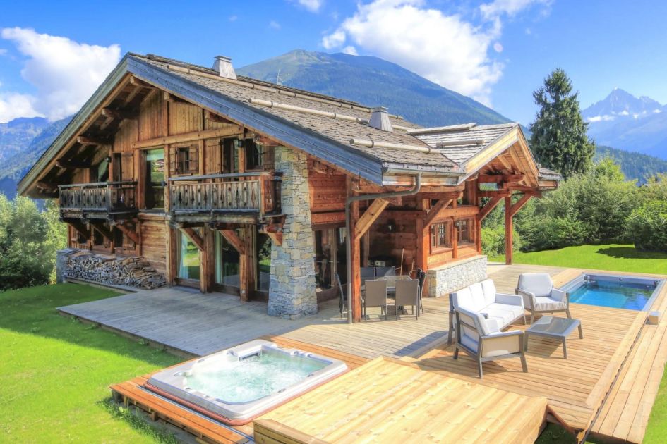 Spacious terrace offering an outdoor swim spa, outdoor hot tub and a lovely alfresco dining spot with views of the surrounding garden.