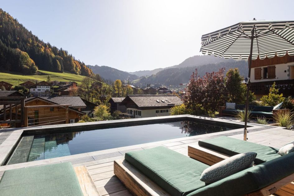 Chalet Doyen's outdoor swimming pool and lovely resort views that can be admired from the pool loungers.