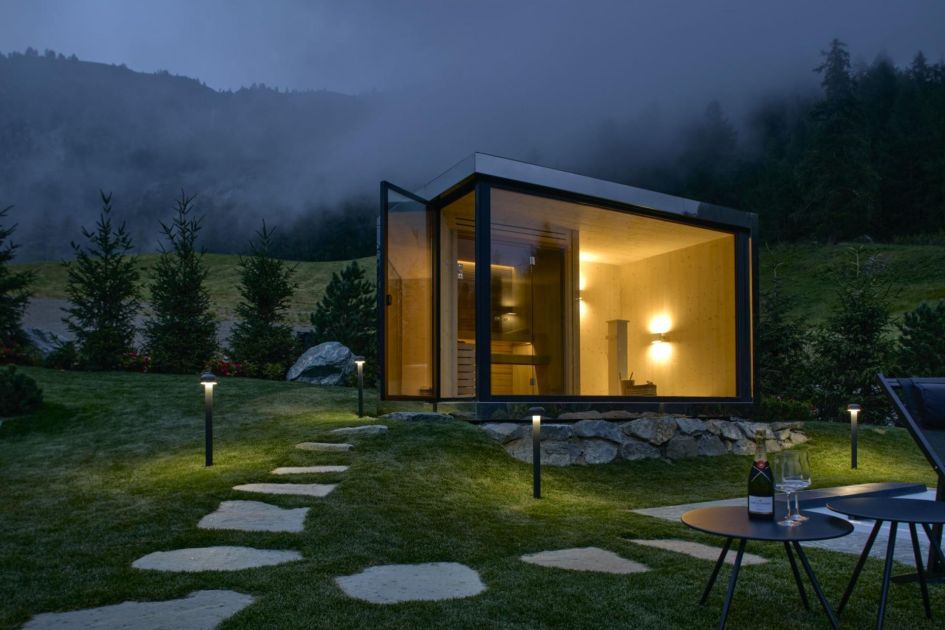 Chalet Hreitage's outdoor Finnish sauna within its private garden with stunning forest surroundings.