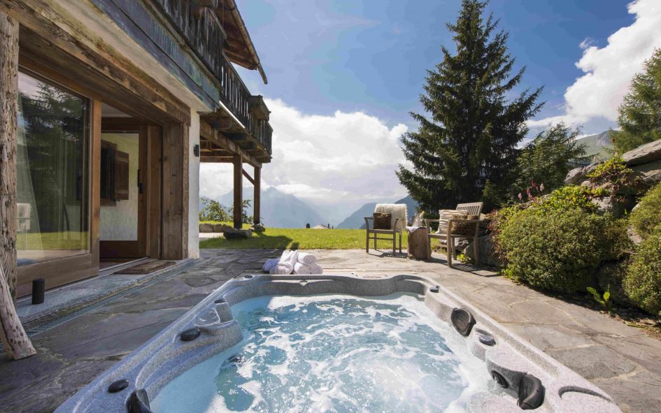 Chalet Milou, Verbier Outdoor sunken hot tub with sensational summer mountain views ahead.